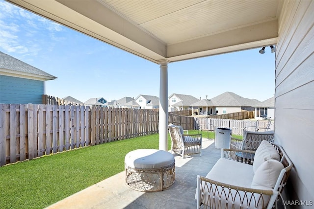 view of patio / terrace with a residential view and a fenced backyard