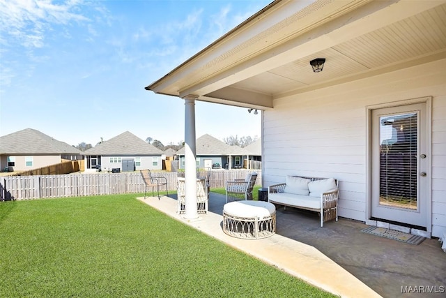 view of yard featuring a patio, fence, and a residential view