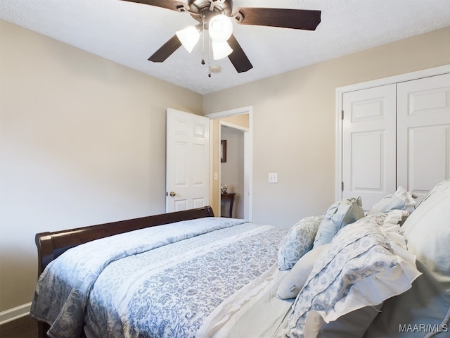 bedroom featuring ceiling fan, a closet, and baseboards