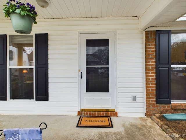 property entrance with brick siding