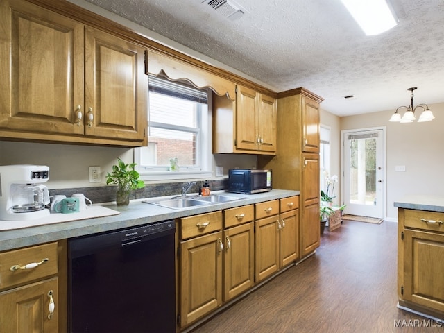 kitchen with visible vents, dishwasher, brown cabinets, dark wood-style flooring, and a sink