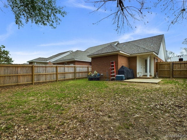 view of yard with a patio area and a fenced backyard