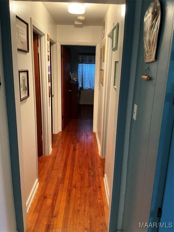 corridor with dark wood finished floors