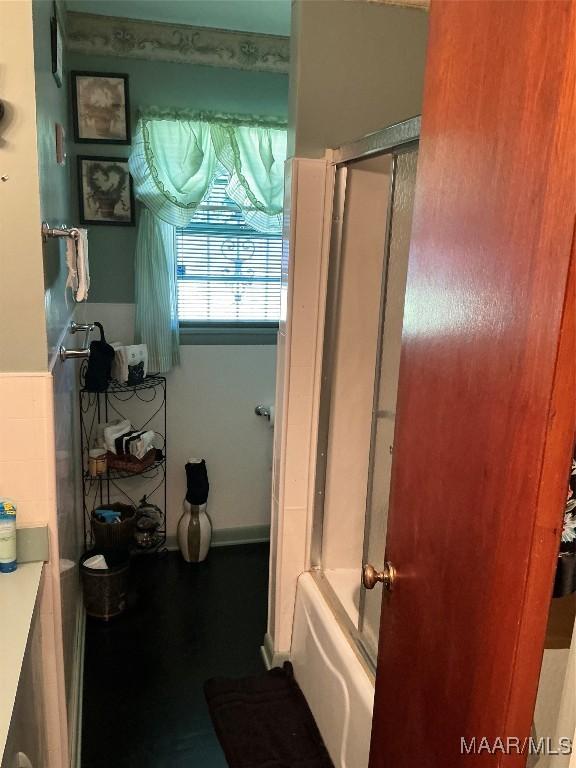 bathroom with vanity and bath / shower combo with glass door