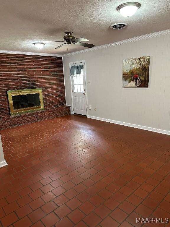 unfurnished living room with ceiling fan, brick floor, visible vents, ornamental molding, and a brick fireplace