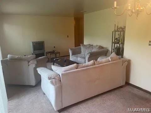 living area with light colored carpet and an inviting chandelier