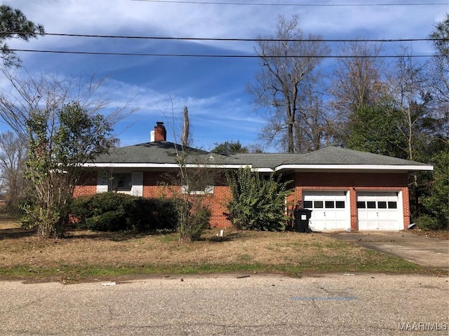 single story home featuring a garage, driveway, brick siding, and a chimney