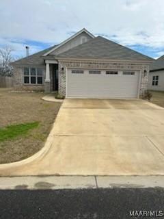 view of front of house featuring concrete driveway and an attached garage