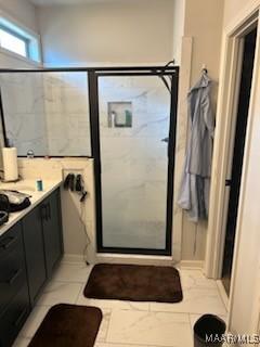 bathroom with a shower stall, vanity, and tile patterned floors