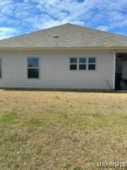 rear view of house with a lawn