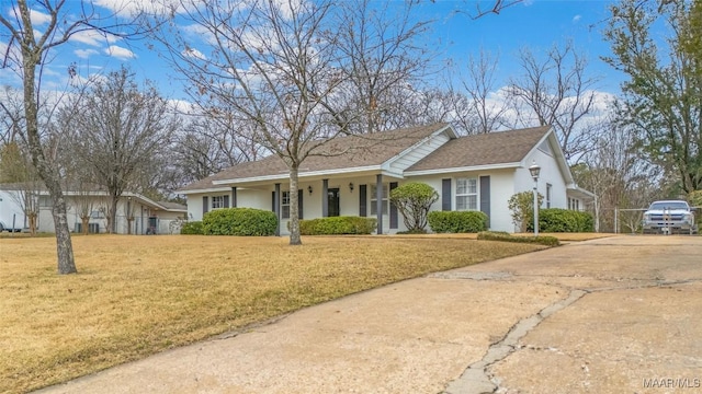 single story home featuring concrete driveway, a front lawn, and stucco siding