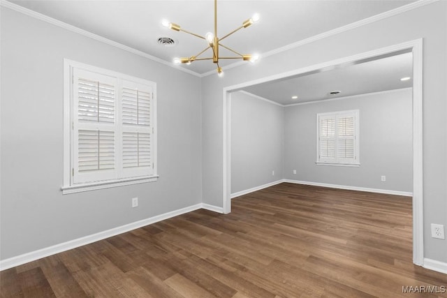 empty room featuring dark wood-style floors, baseboards, visible vents, and ornamental molding