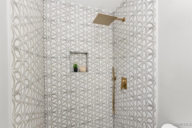 bathroom with tiled shower