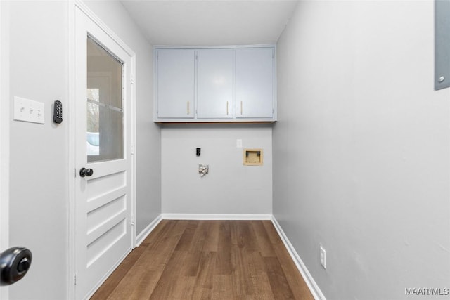 laundry room with washer hookup, cabinet space, baseboards, and wood finished floors