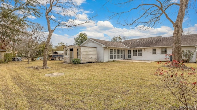 back of property featuring a patio area and a lawn