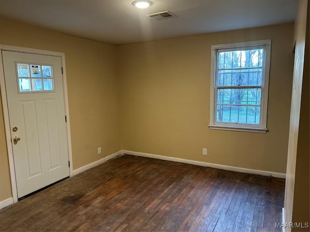 entrance foyer with visible vents, dark wood finished floors, and baseboards