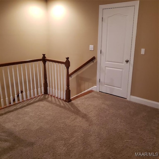 stairs featuring carpet flooring and baseboards