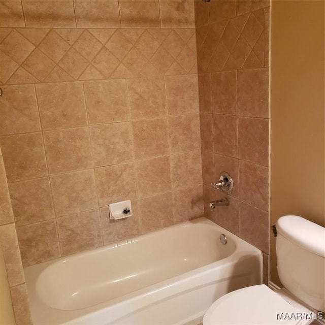 bathroom featuring bathtub / shower combination and toilet