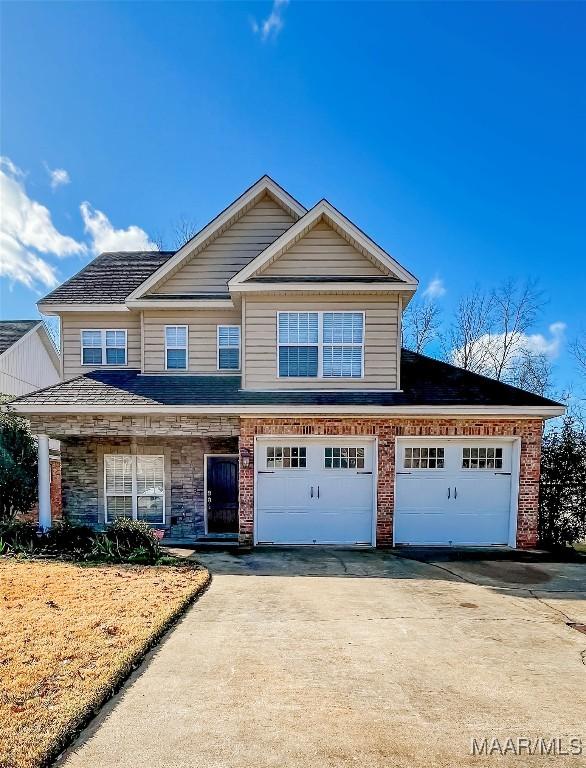 view of front of property with driveway and brick siding