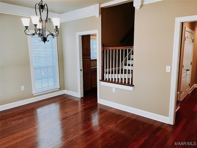 interior space with dark wood-type flooring, baseboards, ornamental molding, stairway, and an inviting chandelier