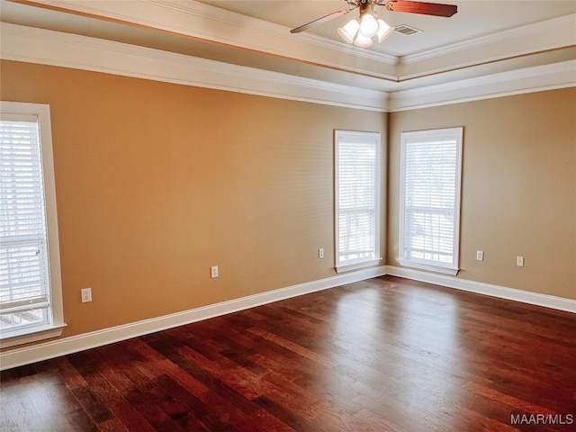 spare room featuring visible vents, baseboards, ceiling fan, dark wood-type flooring, and crown molding