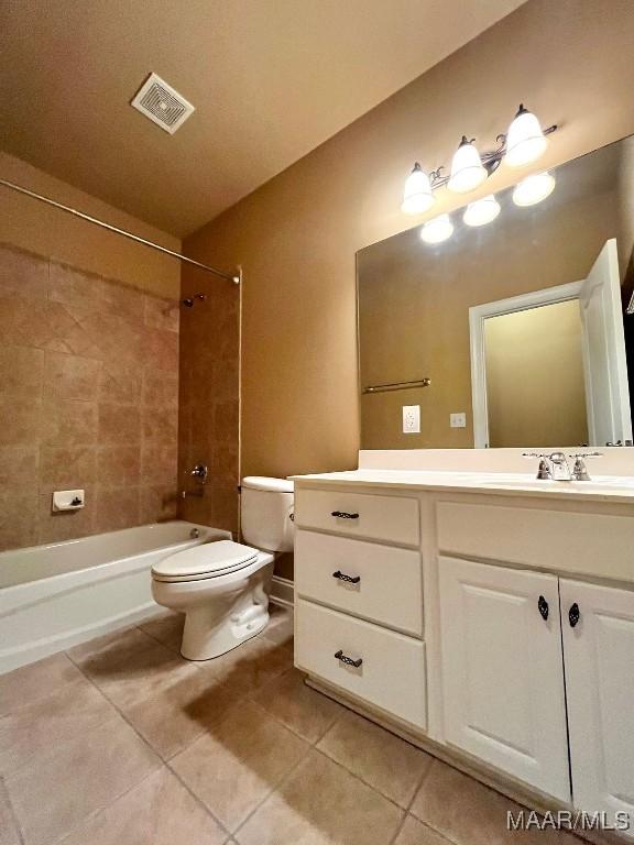 full bath featuring bathing tub / shower combination, visible vents, toilet, vanity, and tile patterned floors