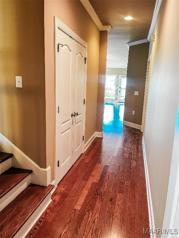 hallway with baseboards, dark wood-style flooring, stairs, and crown molding