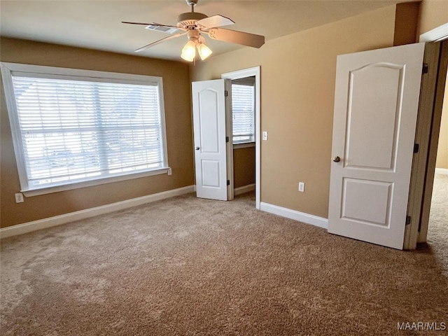 unfurnished bedroom featuring carpet flooring, ceiling fan, and baseboards