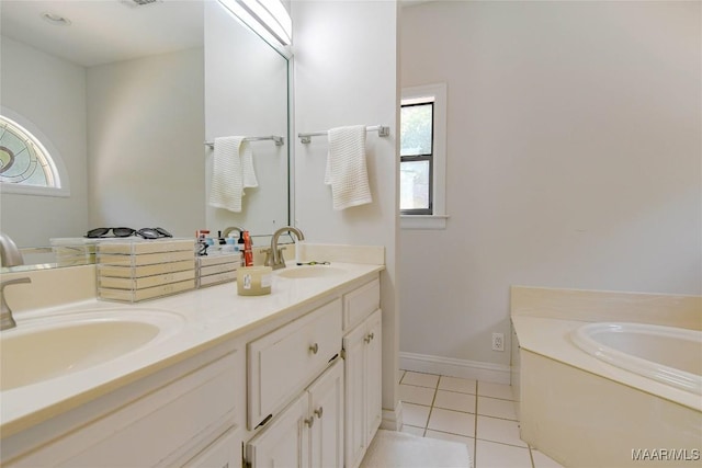 bathroom featuring double vanity, a wealth of natural light, tile patterned flooring, and a sink