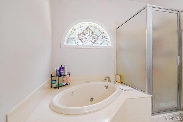 full bath featuring a whirlpool tub and a shower stall