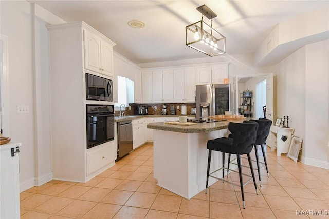 kitchen with white cabinetry, a kitchen island, black appliances, and light tile patterned floors