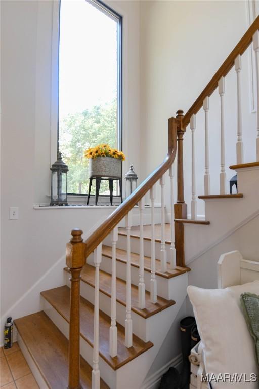 staircase featuring tile patterned flooring