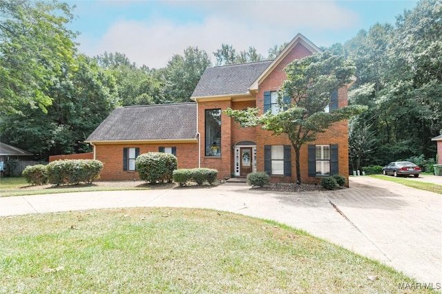 view of front of property with brick siding and a front yard