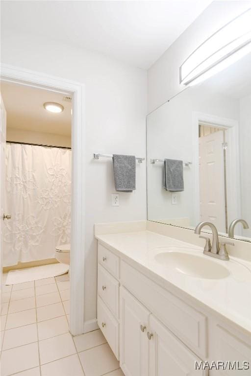 full bath featuring tile patterned flooring, vanity, and toilet