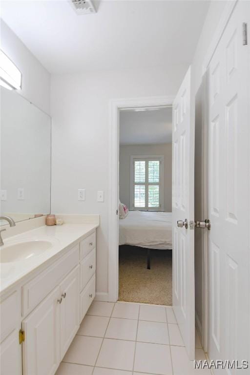 ensuite bathroom with visible vents, vanity, ensuite bath, and tile patterned floors