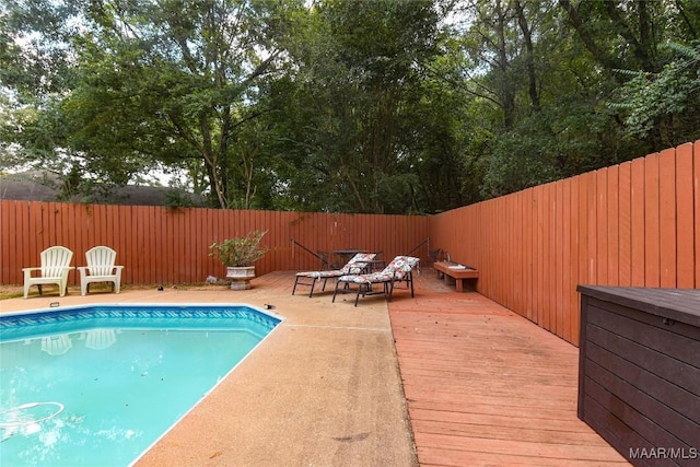 view of swimming pool with a deck, a fenced backyard, and a fenced in pool