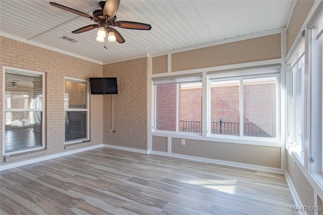 unfurnished sunroom featuring ceiling fan and visible vents