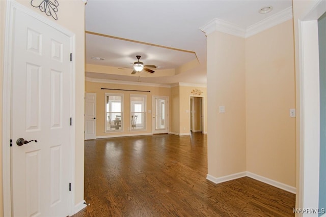 empty room featuring baseboards, ceiling fan, dark wood-style flooring, and crown molding