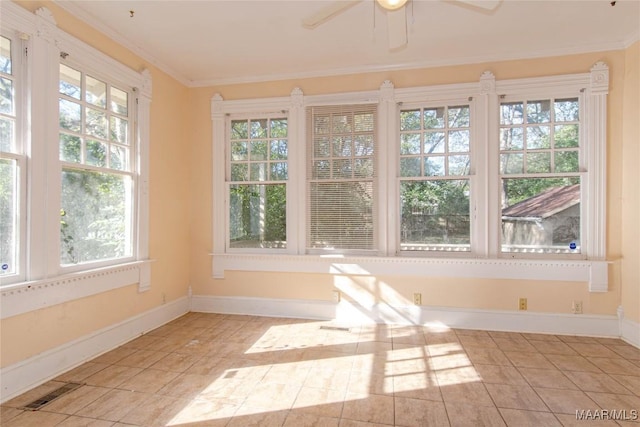 unfurnished sunroom with a wealth of natural light, visible vents, and a ceiling fan