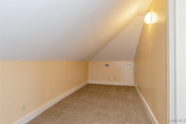 bonus room with lofted ceiling, carpet, visible vents, and baseboards