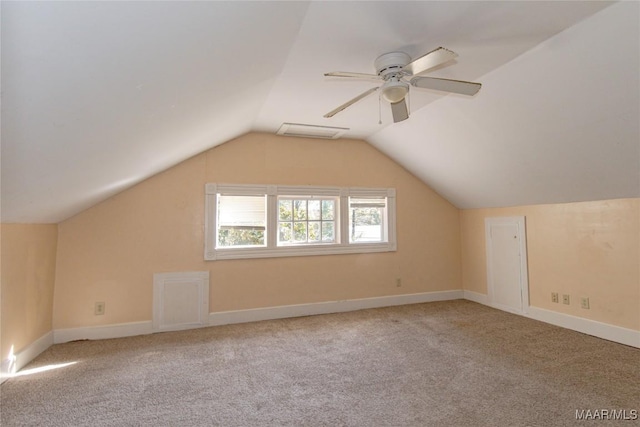 additional living space with carpet floors, baseboards, visible vents, and vaulted ceiling