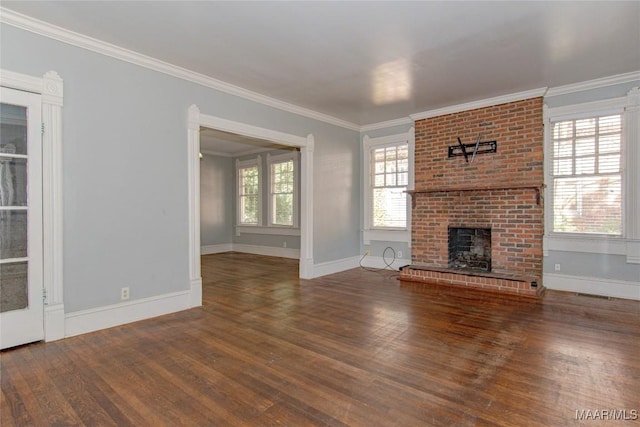 unfurnished living room with dark wood-type flooring, a brick fireplace, and crown molding