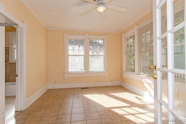 interior space with a ceiling fan, light tile patterned flooring, crown molding, and baseboards