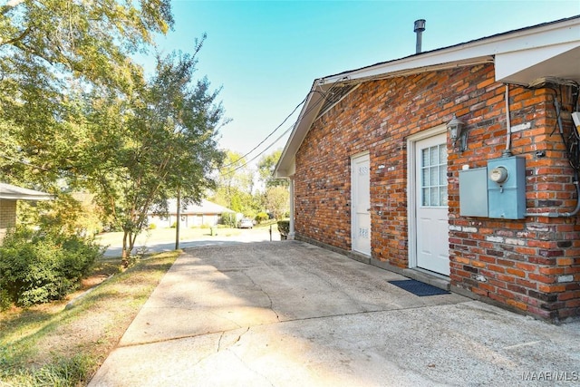 view of side of home featuring brick siding