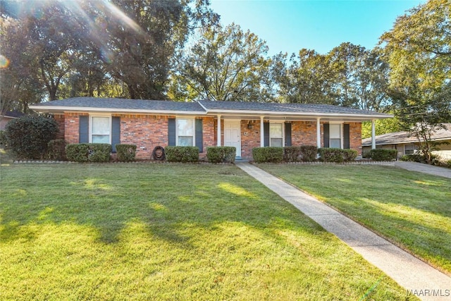 ranch-style house with a front lawn and brick siding