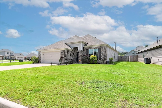 view of front of property featuring central air condition unit, concrete driveway, fence, a garage, and a front lawn