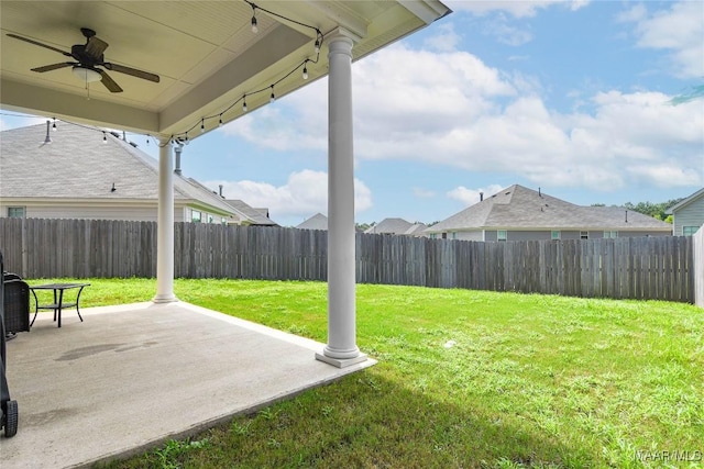 view of yard with ceiling fan, a patio area, and a fenced backyard