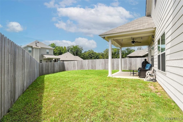 view of yard featuring a fenced backyard, a patio, and ceiling fan