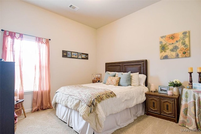 bedroom featuring light carpet and visible vents