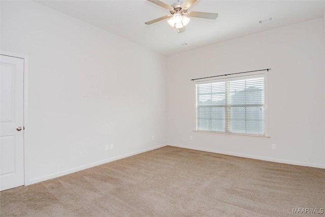 unfurnished room with light carpet, baseboards, visible vents, and a ceiling fan